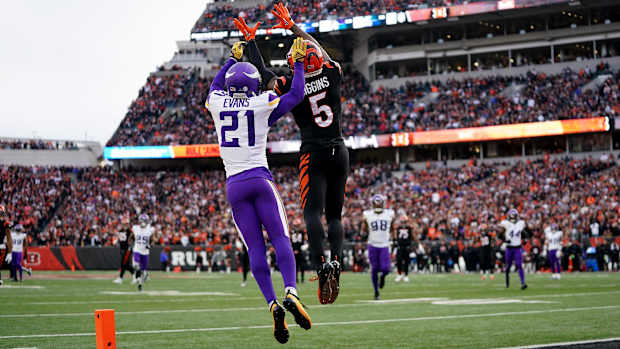 Cincinnati Bengals wide receiver Tee Higgins (5) catches a touchdown pass as Minnesota Vikings cornerback Akayleb Evans (21) defends in the fourth quarter of a Week 15 NFL football game between the Minnesota Vikings and the Cincinnati Bengals, Saturday, Dec. 16, 2023, at Paycor Stadium in Cincinnati. The Cincinnati Bengals won 27-24 in overtime.